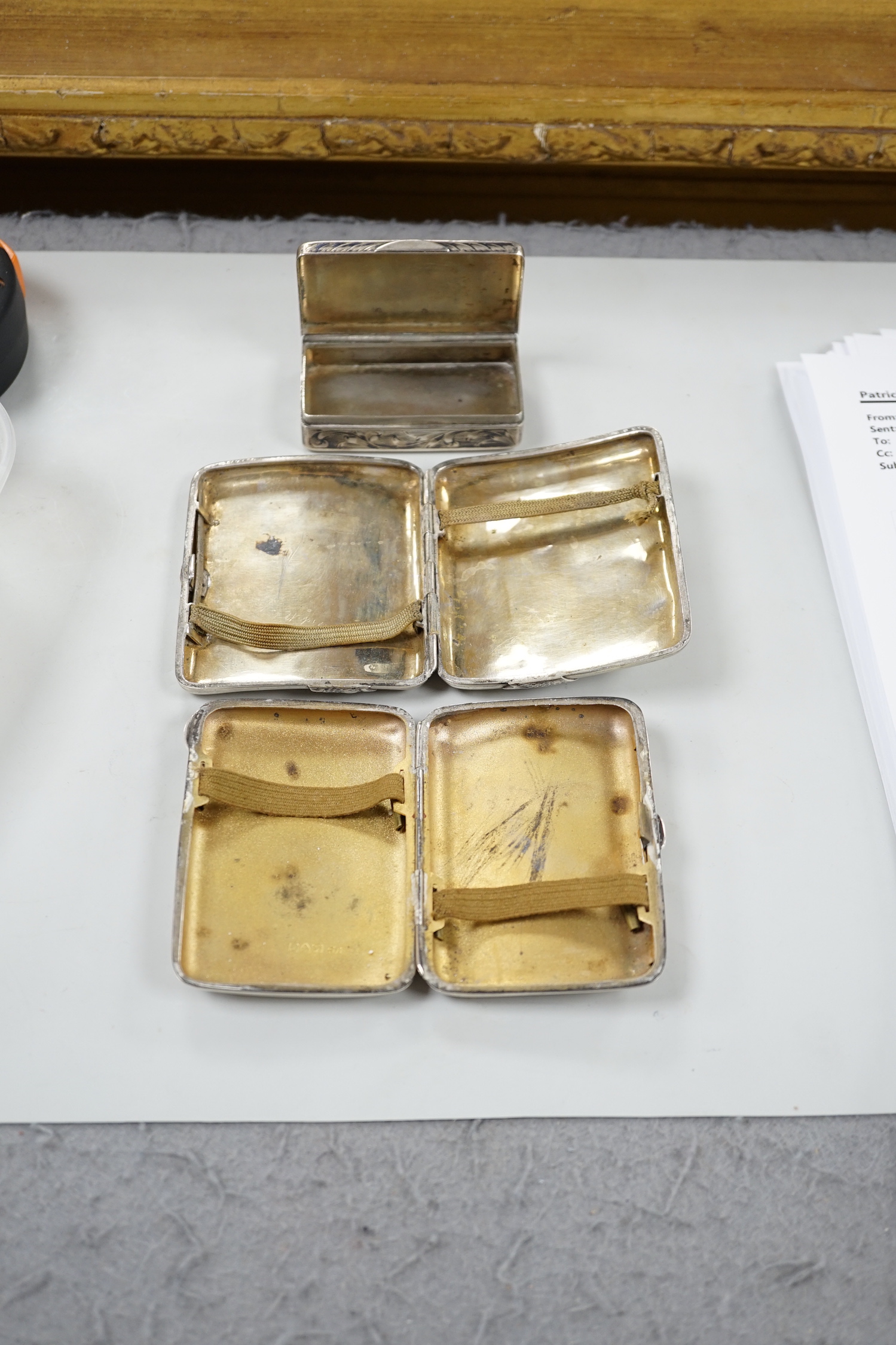 A white metal cigarette case, with applied dragon, 82mm, one other silver cigarette case and a Russian 84 zolotnik snuff box(tired).